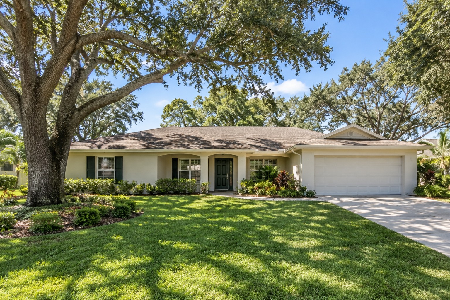 A Central Florida ranch style home exterior with mature oak trees, illustrative